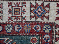 A close-up of an Afghan Super Kazakh runner featuring traditional geometric motifs in wool.