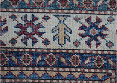 A close-up of an Afghan Super Kazakh runner featuring traditional geometric motifs in wool.