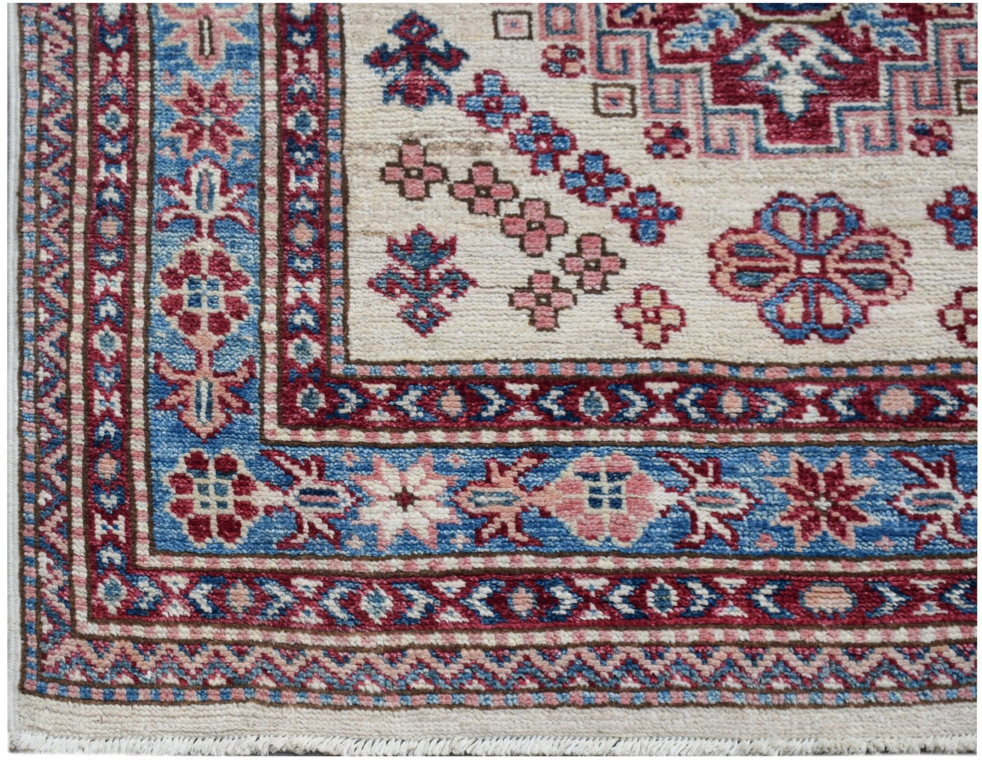 A handmade Afghan Super Kazakh runner featuring traditional geometric motifs in red and blue.