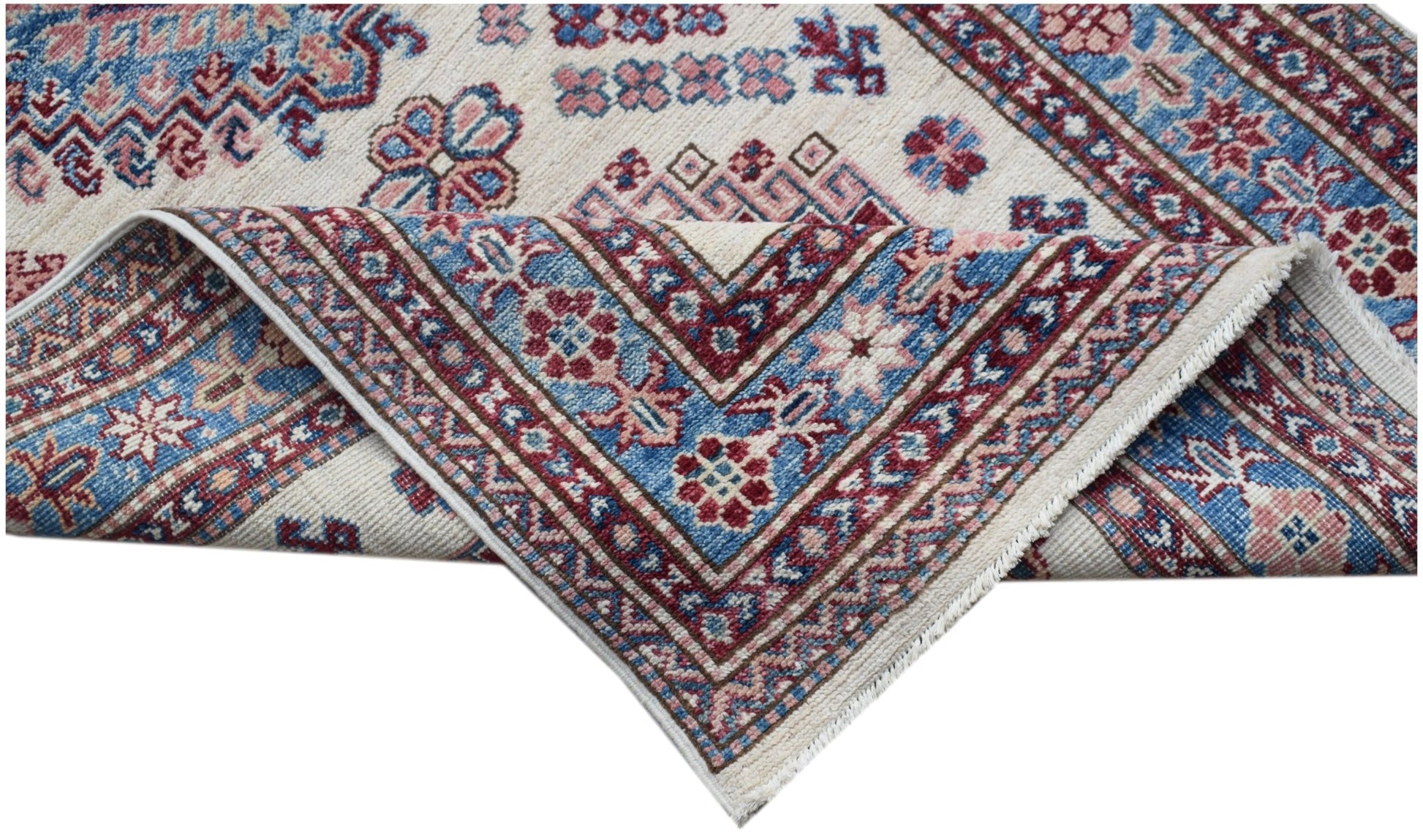 An Afghan Super Kazakh runner with traditional geometric motifs in blue, red, and cream wool.