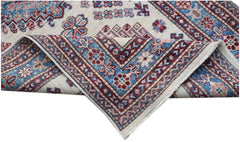 An Afghan Super Kazakh runner with traditional geometric motifs in blue, red, and cream wool.