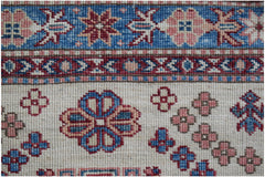 Handmade Afghan Super Kazakh runner featuring traditional floral motifs in blue and pink wool.