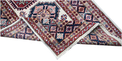 A handmade Afghan Super Kazakh runner featuring traditional geometric motifs in red and blue.