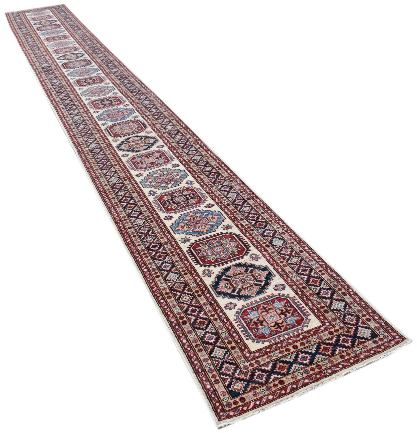 A long, handmade Afghan Super Kazakh runner rug featuring traditional geometric motifs in red and blue.
