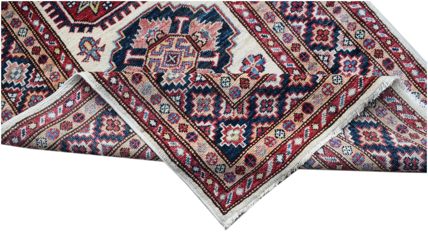 A handmade Afghan Super Kazakh runner featuring traditional geometric motifs in red and blue.