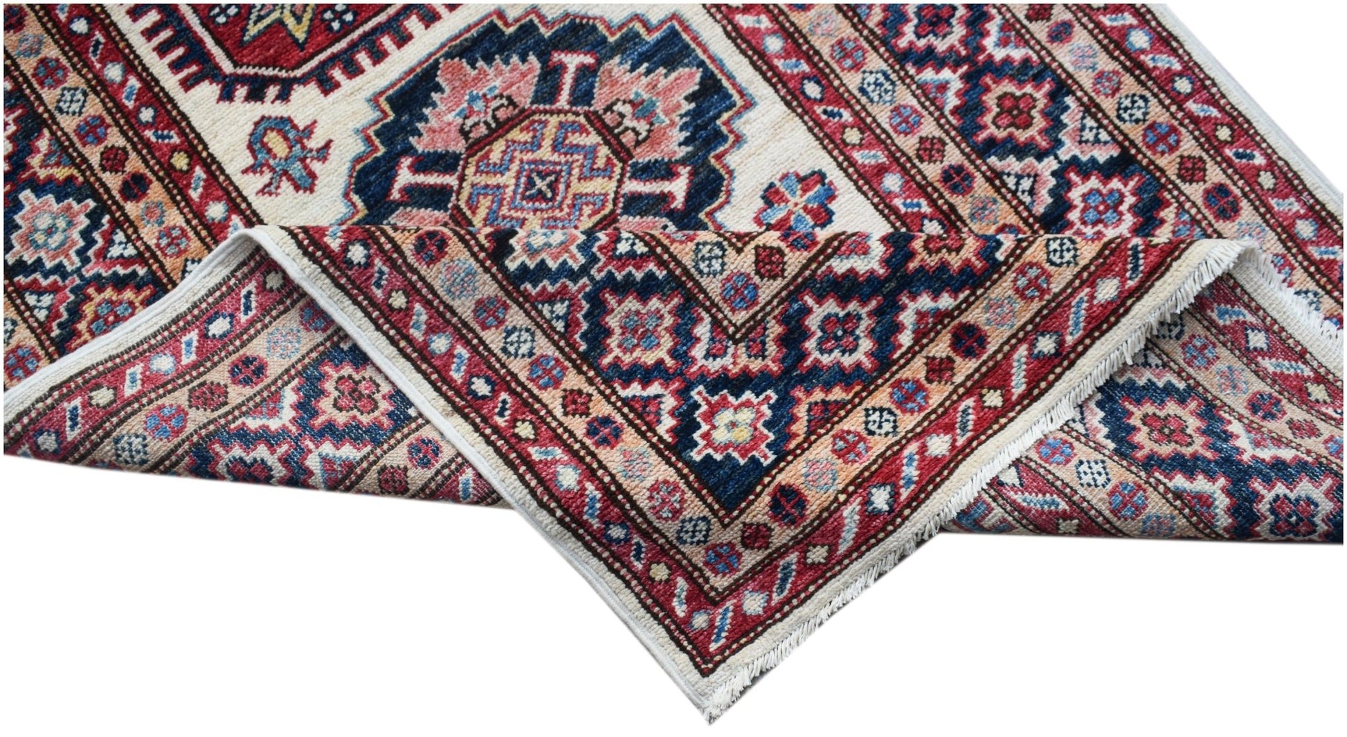 A handmade Afghan Super Kazakh runner featuring traditional geometric motifs in red and blue.