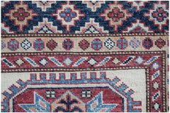 Handmade Afghan Super Kazakh runner featuring traditional geometric motifs in red, blue, and cream.