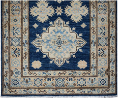 Handmade Afghan Super Kazakh runner rug featuring a blue field with beige geometric medallions.