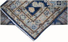 A handmade Afghan Super Kazakh runner featuring a geometric pattern in blue and beige wool.
