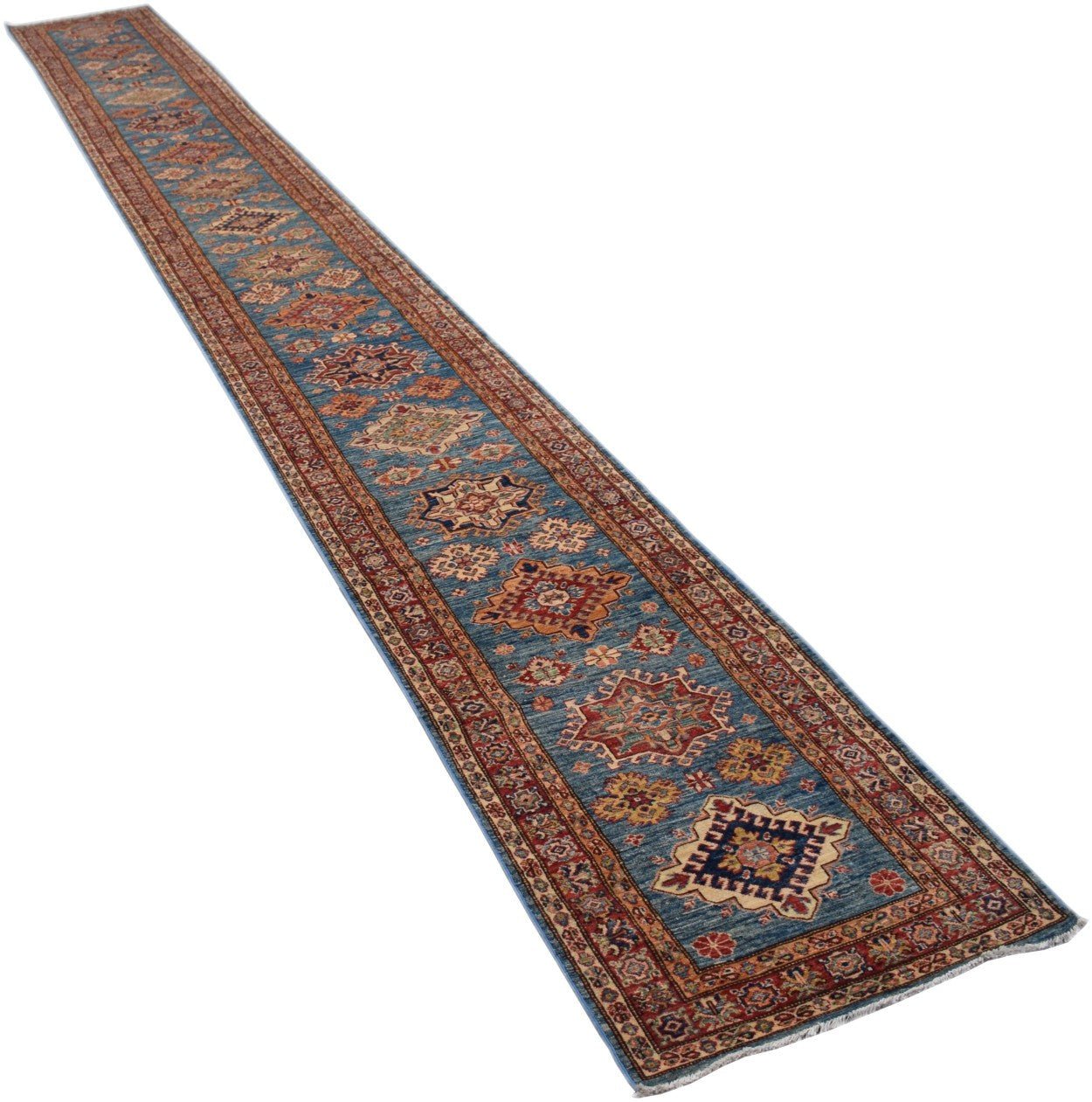 A long, handmade Afghan Super Kazakh runner rug featuring geometric patterns on a blue background.