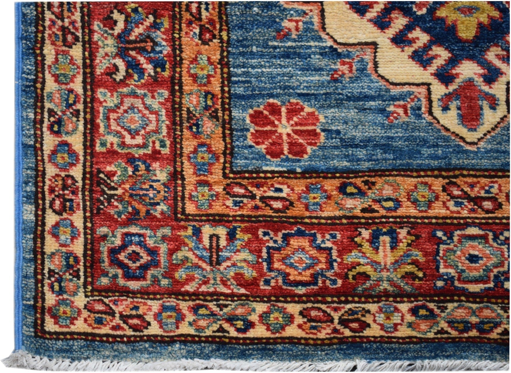 A handmade Afghan Super Kazakh runner featuring a blue field with red floral and geometric motifs.