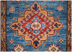 Handmade Afghan runner rug featuring a central geometric medallion in red, orange, and blue.