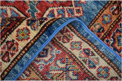A close-up view of a handmade Afghan Super Kazakh runner featuring intricate geometric patterns.