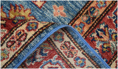 A close-up of a handmade Afghan Super Kazakh runner featuring intricate geometric floral patterns.