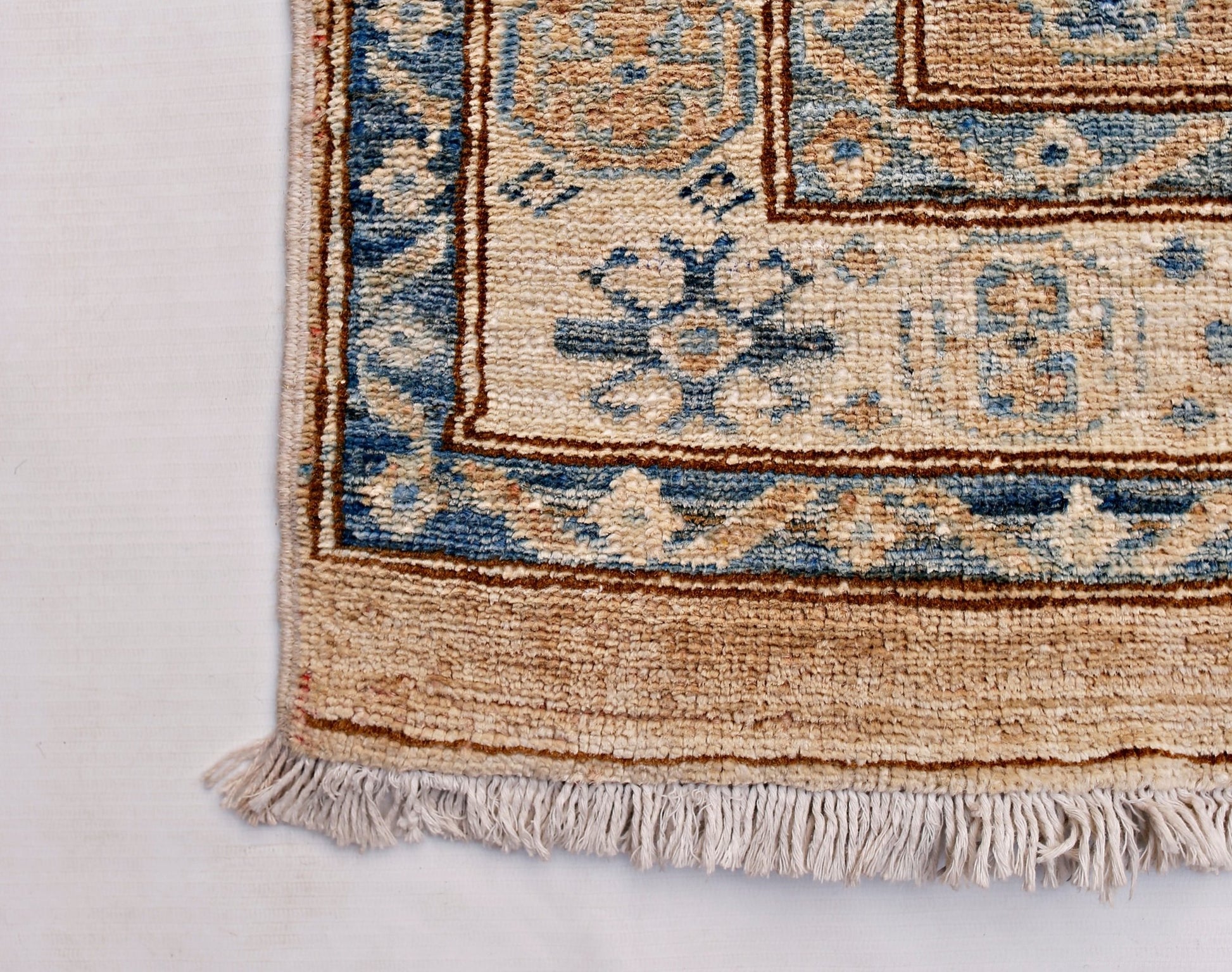 A handmade Afghan Super Kazakh runner featuring traditional blue and beige geometric motifs.