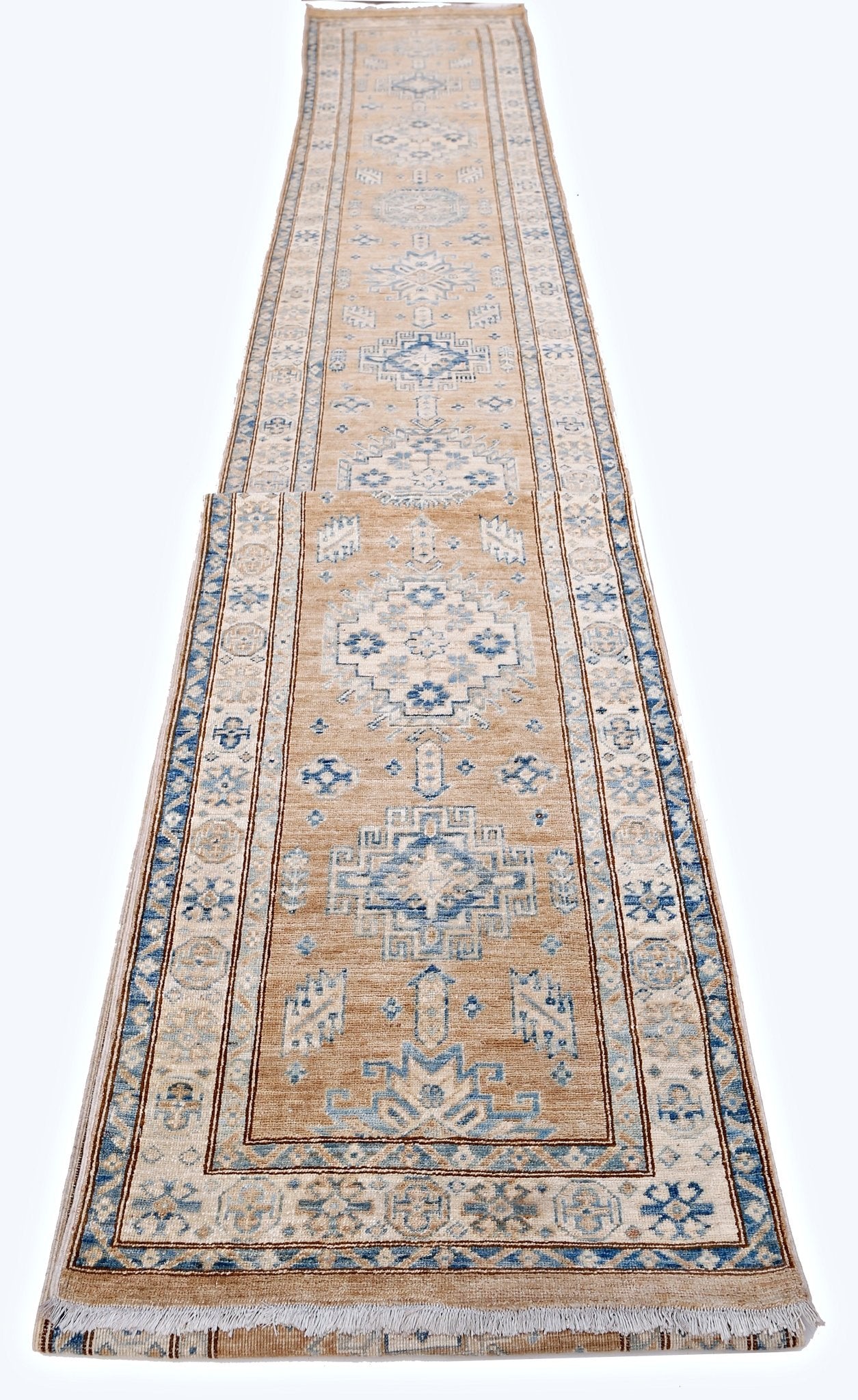 A long, handmade Afghan Super Kazakh runner rug featuring traditional blue geometric motifs on tan.