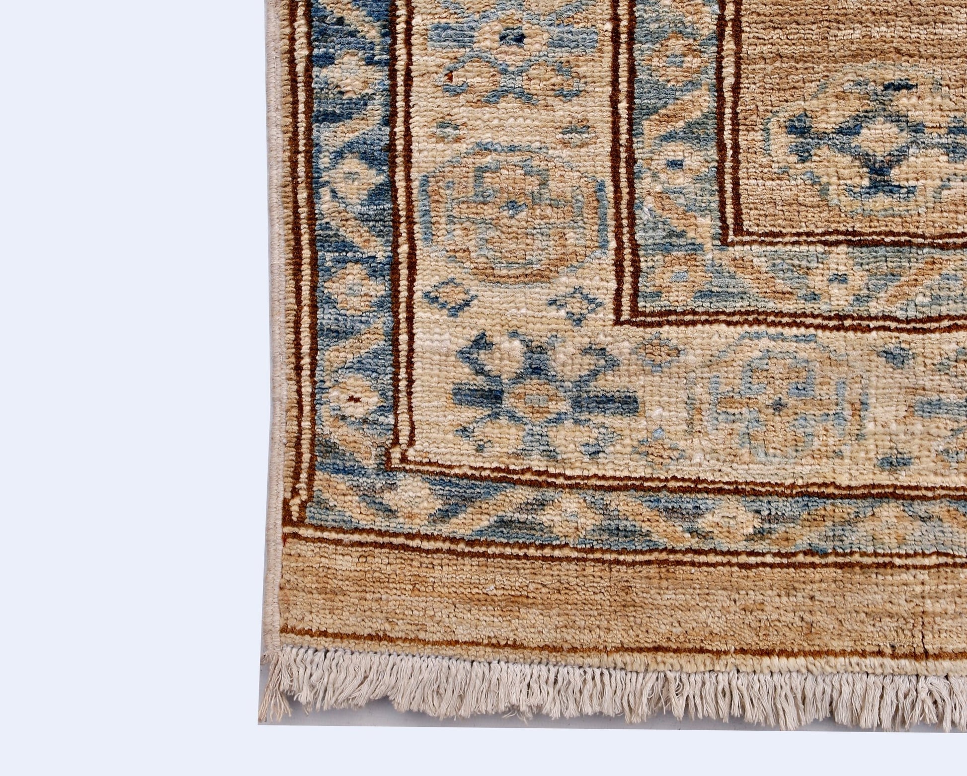 A handmade Afghan Super Kazakh runner featuring traditional blue and tan geometric motifs.