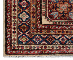 A handmade Afghan Super Kazakh runner featuring traditional geometric motifs in red and blue.