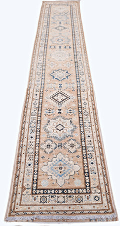 A long, handmade Afghan Super Kazakh runner rug featuring traditional geometric motifs in blue.