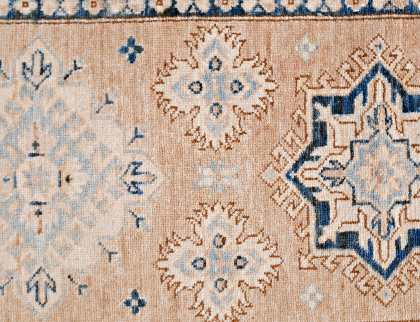 A handmade Afghan Super Kazakh runner featuring traditional blue and cream geometric motifs.