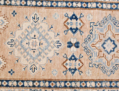 A handmade Afghan Super Kazakh runner featuring traditional geometric motifs in blue and beige.