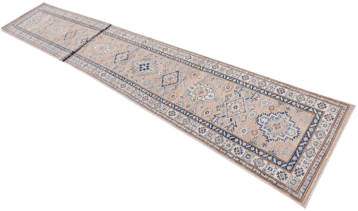 A long, handmade Afghan Super Kazakh runner rug featuring traditional blue and beige geometric motifs.