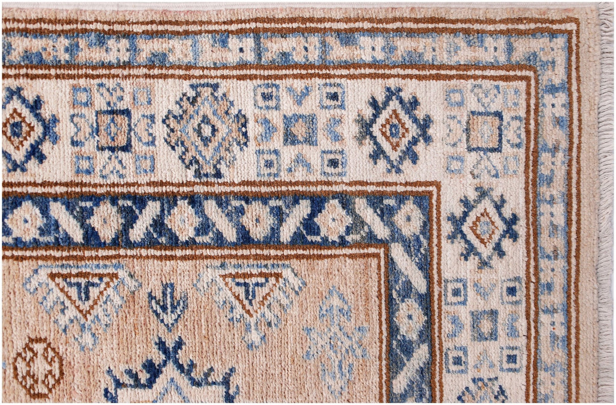 A handmade Afghan Super Kazakh runner featuring traditional blue and brown geometric motifs.