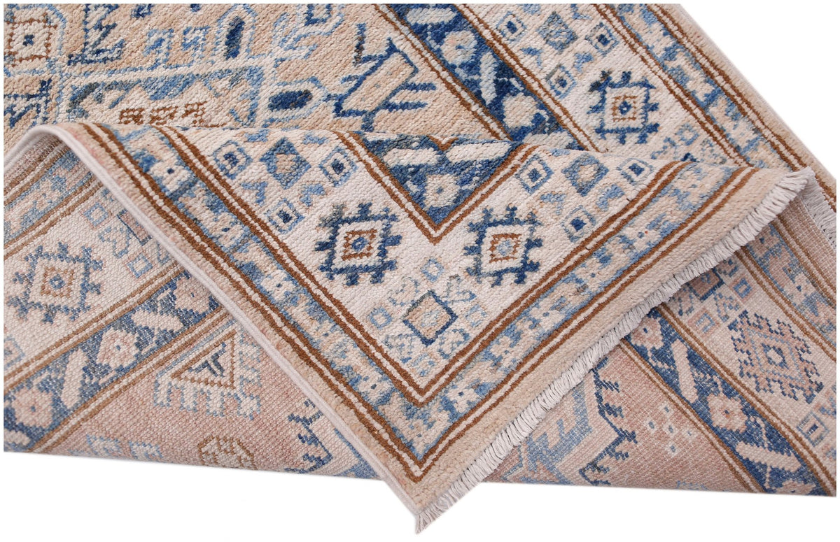 A handmade Afghan Super Kazakh runner featuring traditional blue and tan geometric patterns.
