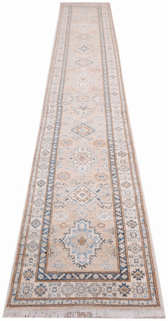 A long, handmade Afghan Super Kazakh runner rug featuring traditional geometric motifs in blue and tan.