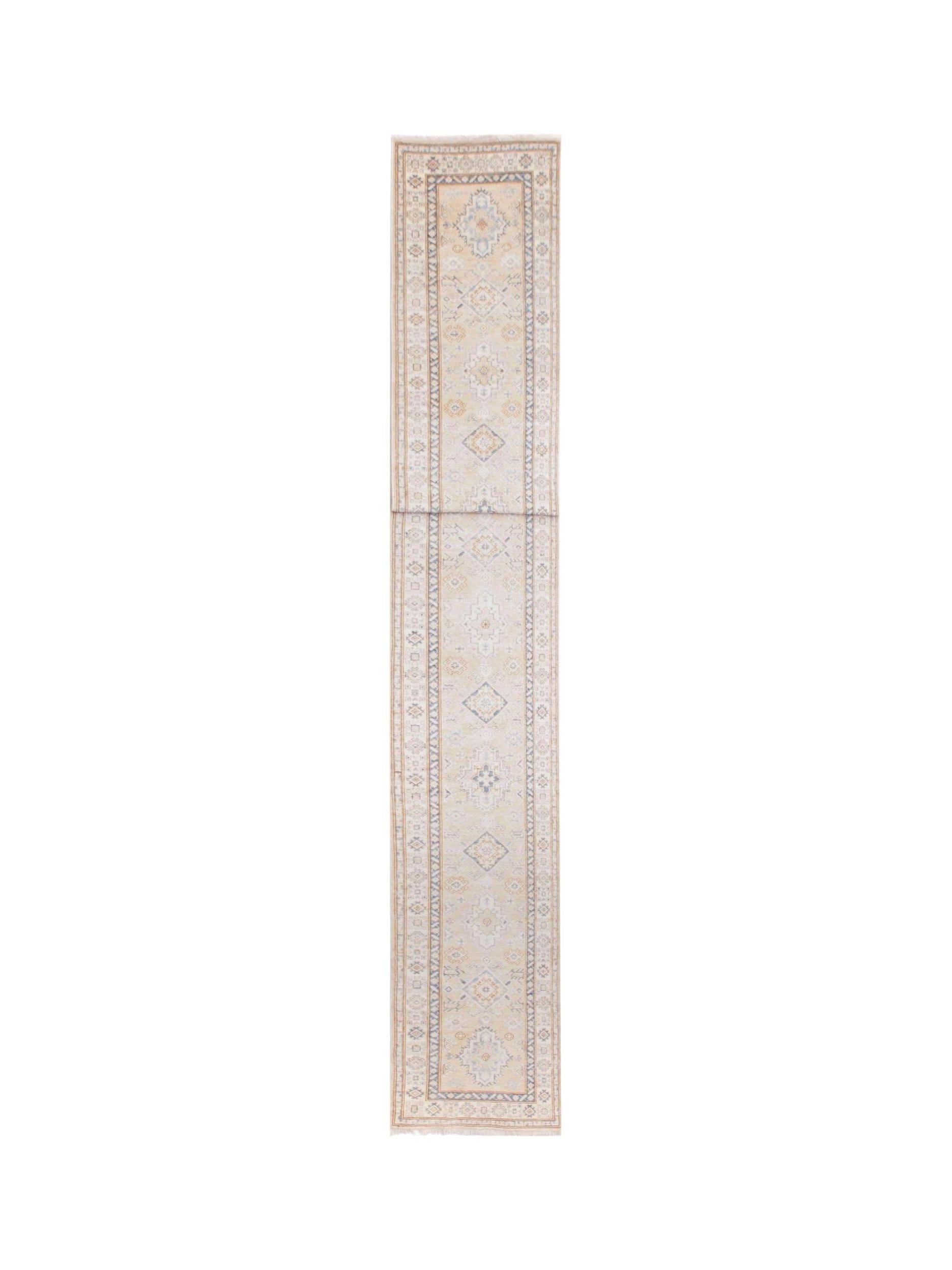 A long, handmade Afghan Super Kazakh runner rug featuring traditional geometric motifs in soft tones.