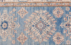 An Afghan Super Kazakh runner featuring traditional geometric motifs in blue, cream, and pink.