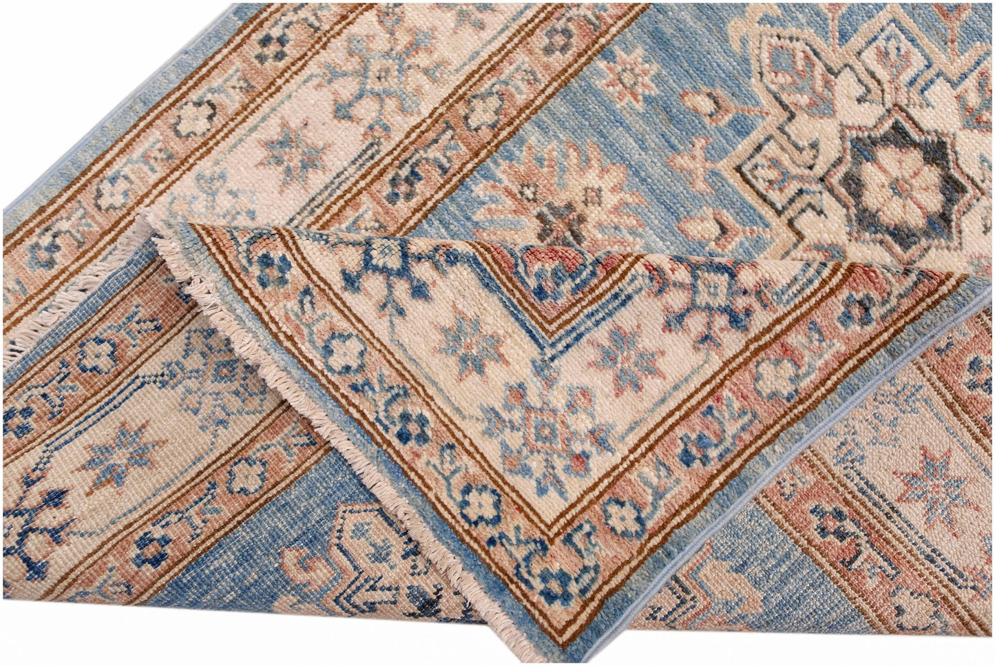 A folded Afghan Super Kazakh runner featuring traditional blue and cream floral patterns.