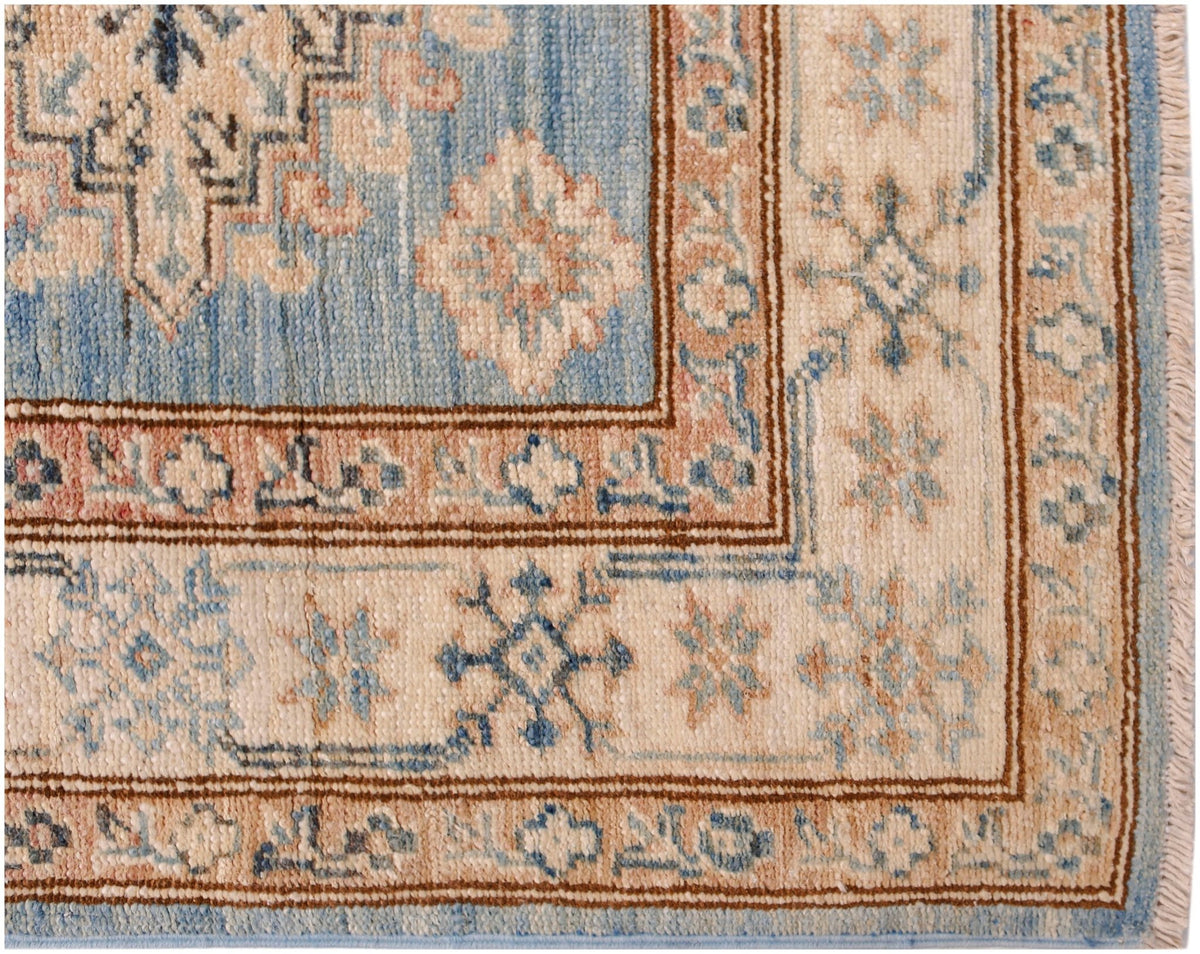 A handmade Afghan Super Kazakh runner featuring traditional geometric motifs in blue and beige.