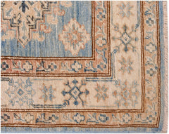 A handmade Afghan Super Kazakh runner featuring traditional geometric motifs in blue and beige.