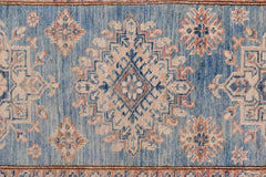 An Afghan Super Kazakh runner featuring traditional geometric motifs in blue, cream, and pink.