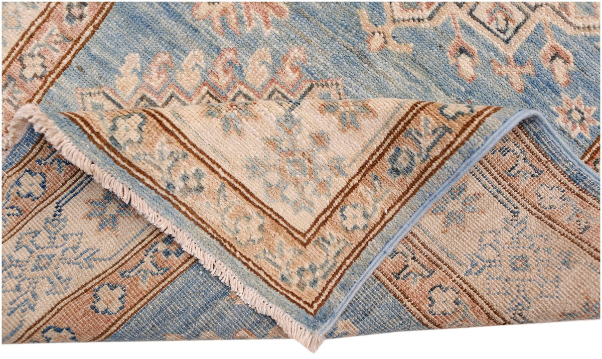 A handmade Afghan Super Kazakh runner featuring traditional motifs in blue, cream, and brown tones.
