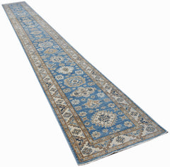 A long, handmade Afghan Super Kazakh runner rug featuring traditional blue and beige geometric motifs.