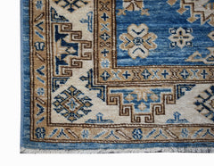 A handmade Afghan Super Kazakh runner featuring traditional geometric motifs in blue and beige.