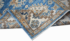 A handmade Afghan Super Kazakh runner featuring traditional geometric motifs in blue and beige.
