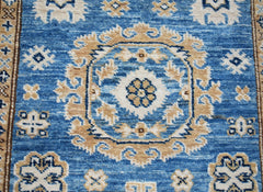 Handmade Afghan Super Kazakh runner rug featuring traditional blue and beige geometric motifs.