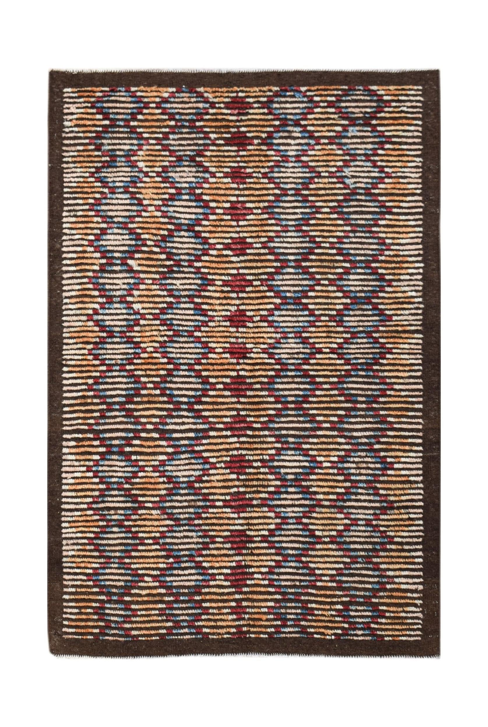 An Afghan Yekta rug featuring a geometric pattern in red, blue, and orange on a textured background.