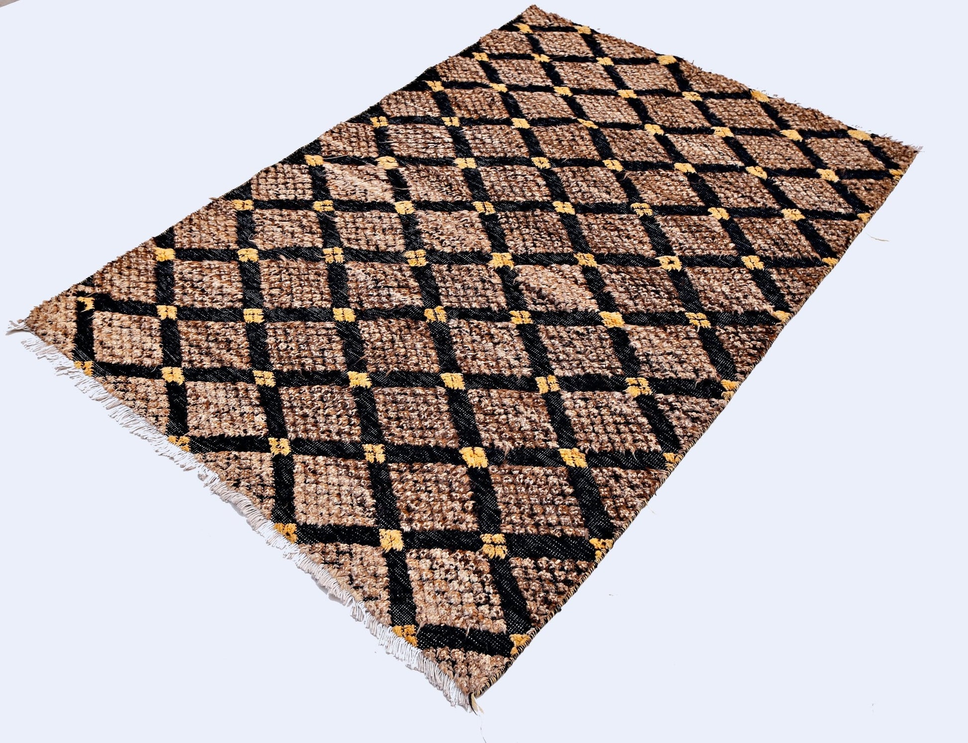 An Afghan Yekta rug featuring a brown and black diamond pattern with yellow accents and fringe.