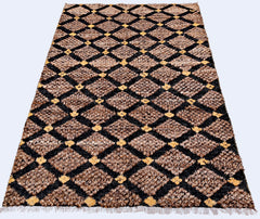 An Afghan Yekta rug featuring a brown and black diamond pattern with yellow accents and fringe.