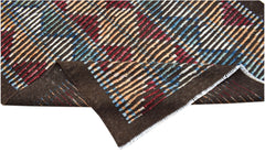 An Afghan Yekta rug featuring a dark brown base with colorful, hand-knotted striped patterns.