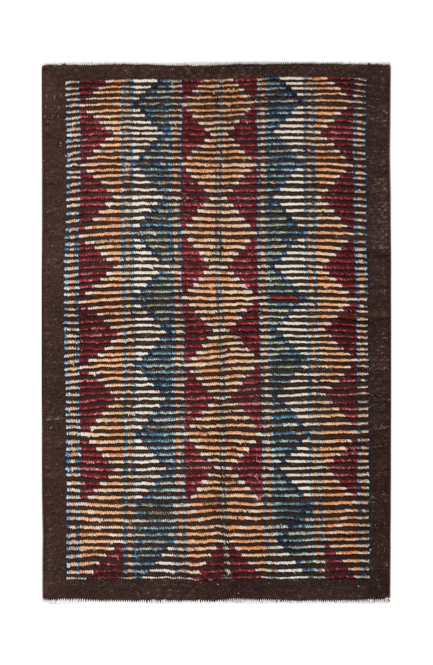 An Afghan Yekta rug featuring a dark brown background with bold, geometric horizontal patterns.