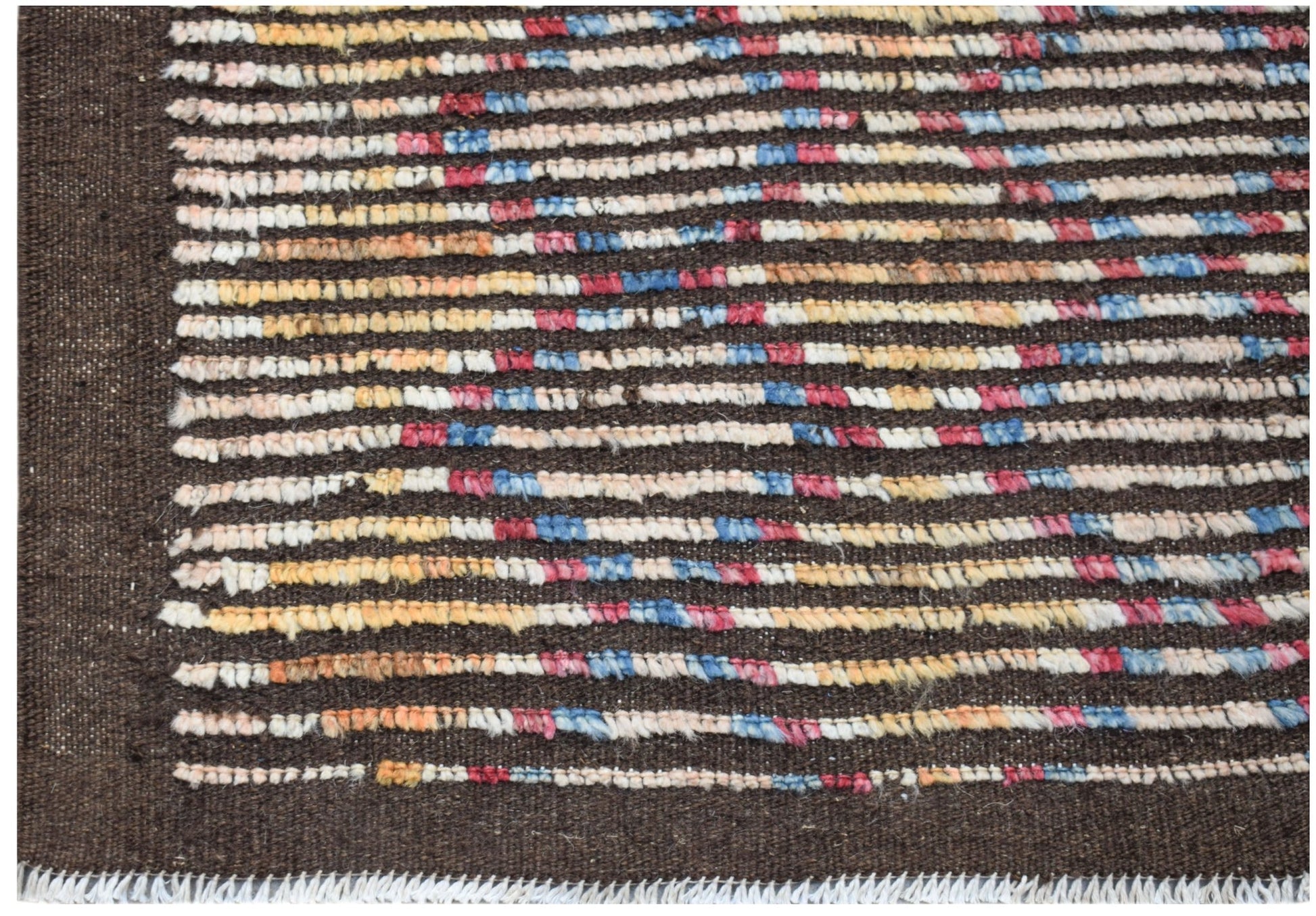 An Afghan Yekta rug featuring horizontal stripes of multicolored wool on a dark brown background.