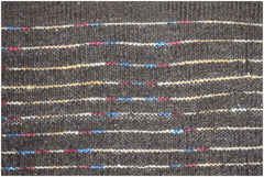 A dark brown hand-knotted wool rug featuring horizontal stripes with small colorful accents.