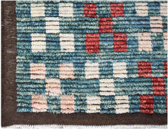A hand-knotted Afghan rug featuring a blue field with a geometric grid of red, white, and pink squares.
