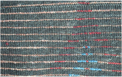 A close-up of a hand-knotted Afghan rug featuring dark wool with horizontal red and blue stripes.