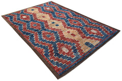 An Afghan Yekta rug featuring a bold geometric pattern in red, blue, and cream wool.